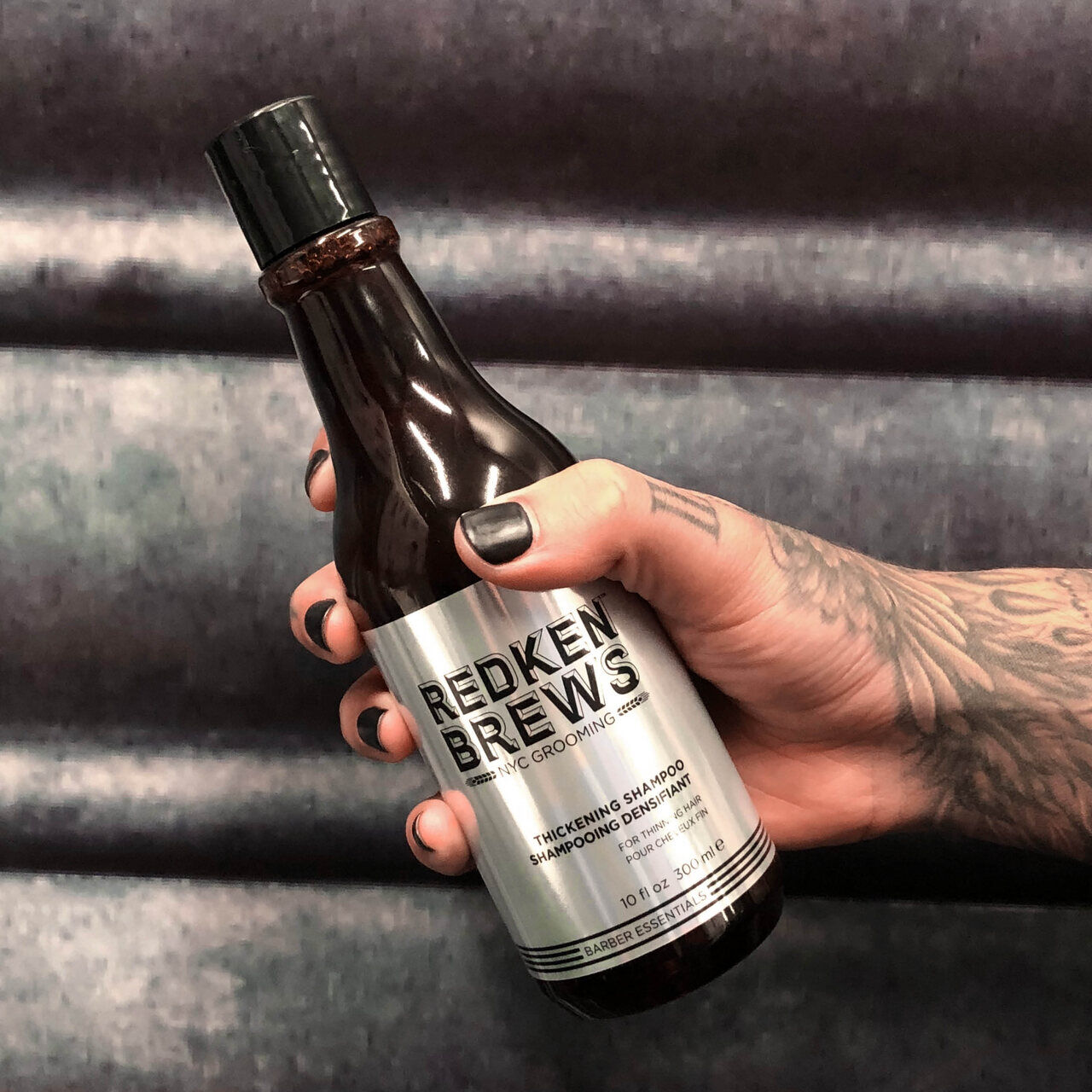 REDKEN BREWS THICKENING SHAMPOO IN HAND