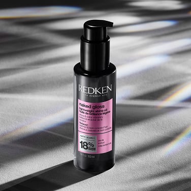 A bottle of Redken's Naked Gloss Lightweight Shine OIl