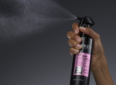 A bottle of Redken Acidic Gloss Conditioner on a white background.