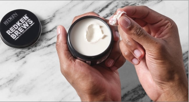 Discover Redken Brews Outplay Texture Pomade in hand