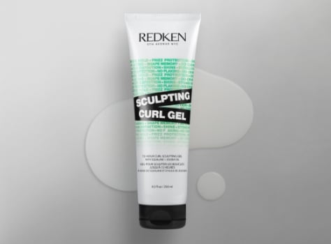 A bottle of Redken Acidic Bonding Sculpting Curl Gel on a white background.