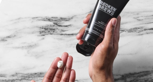 Discover Redken Brews work hard molding paste in hand