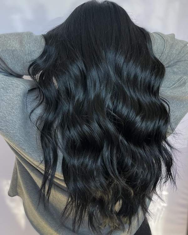 Woman with long, wavy black hair.