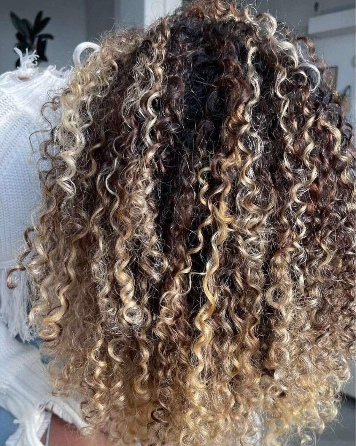 Woman with a long, blonde fishtail braid.